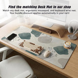 Sage green ergonomic mousepad and keyboard wrist rest with abstract shapes, soft gray details, cream space, topographic contour lines, and leafy branch accents.