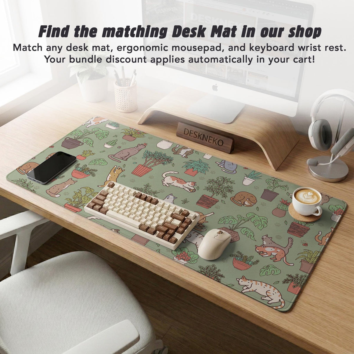 Sage green desk mat with a pattern of lounging cats, leafy plants, cactus pots, and earthy botanical details.