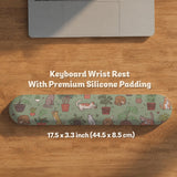 Sage green desk mat with a pattern of lounging cats, leafy plants, cactus pots, and earthy botanical details.