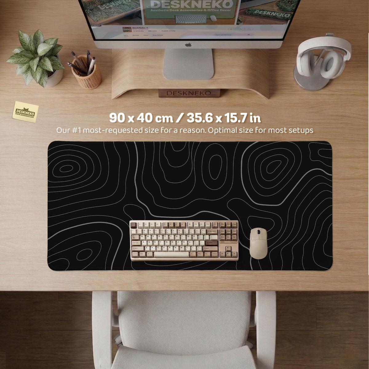 Black desk mat with a thin gray topographic contour line pattern.