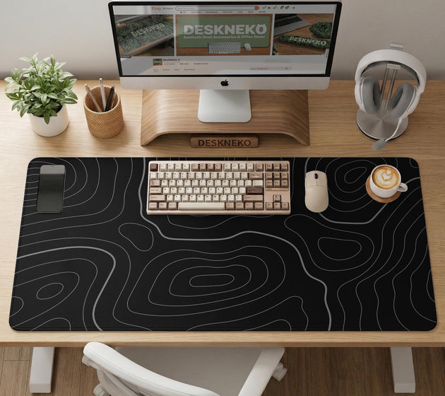 Black desk mat with a thin gray topographic contour line pattern.