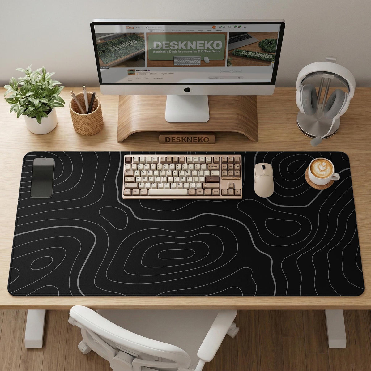 Black desk mat with a thin gray topographic contour line pattern.