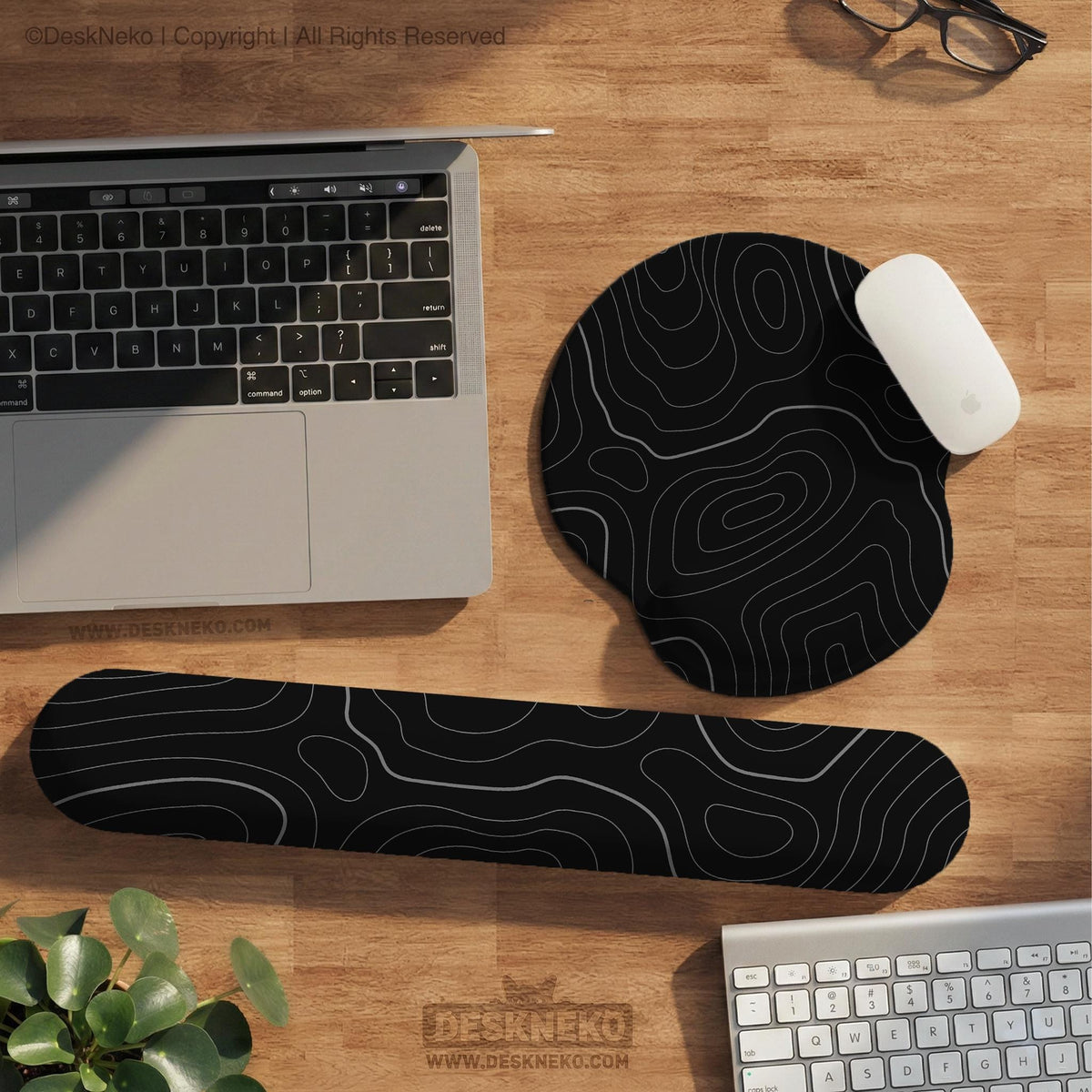 Black mousepad with a gray topographic contour line pattern shown with matching keyboard wrist rest options.