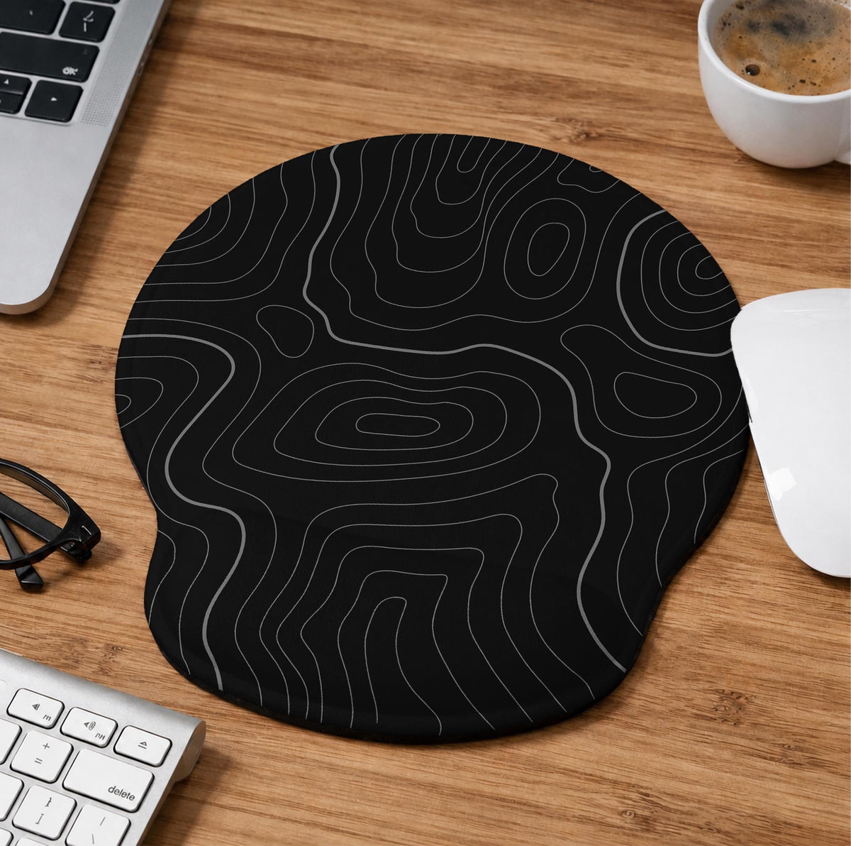 Black mousepad with a gray topographic contour line pattern shown with matching keyboard wrist rest options.