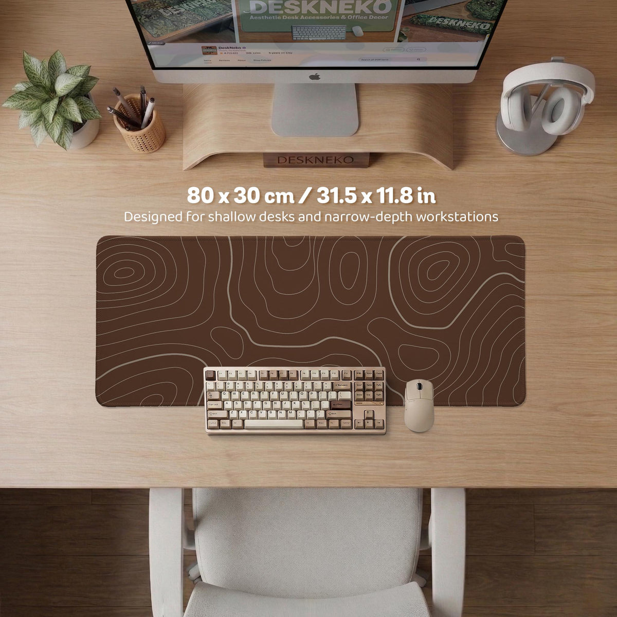 Brown desk mat with a repeating topographic contour line pattern in a neutral earth tone design.