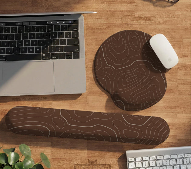 Brown mousepad and keyboard wrist rest with a topographic contour-line pattern.
