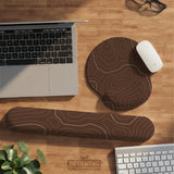Brown mousepad and keyboard wrist rest with a topographic contour-line pattern.