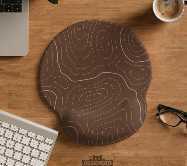 Brown mousepad and keyboard wrist rest with a topographic contour-line pattern.
