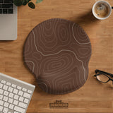 Brown mousepad and keyboard wrist rest with a topographic contour-line pattern.
