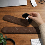 Brown mousepad and keyboard wrist rest with a topographic contour-line pattern.