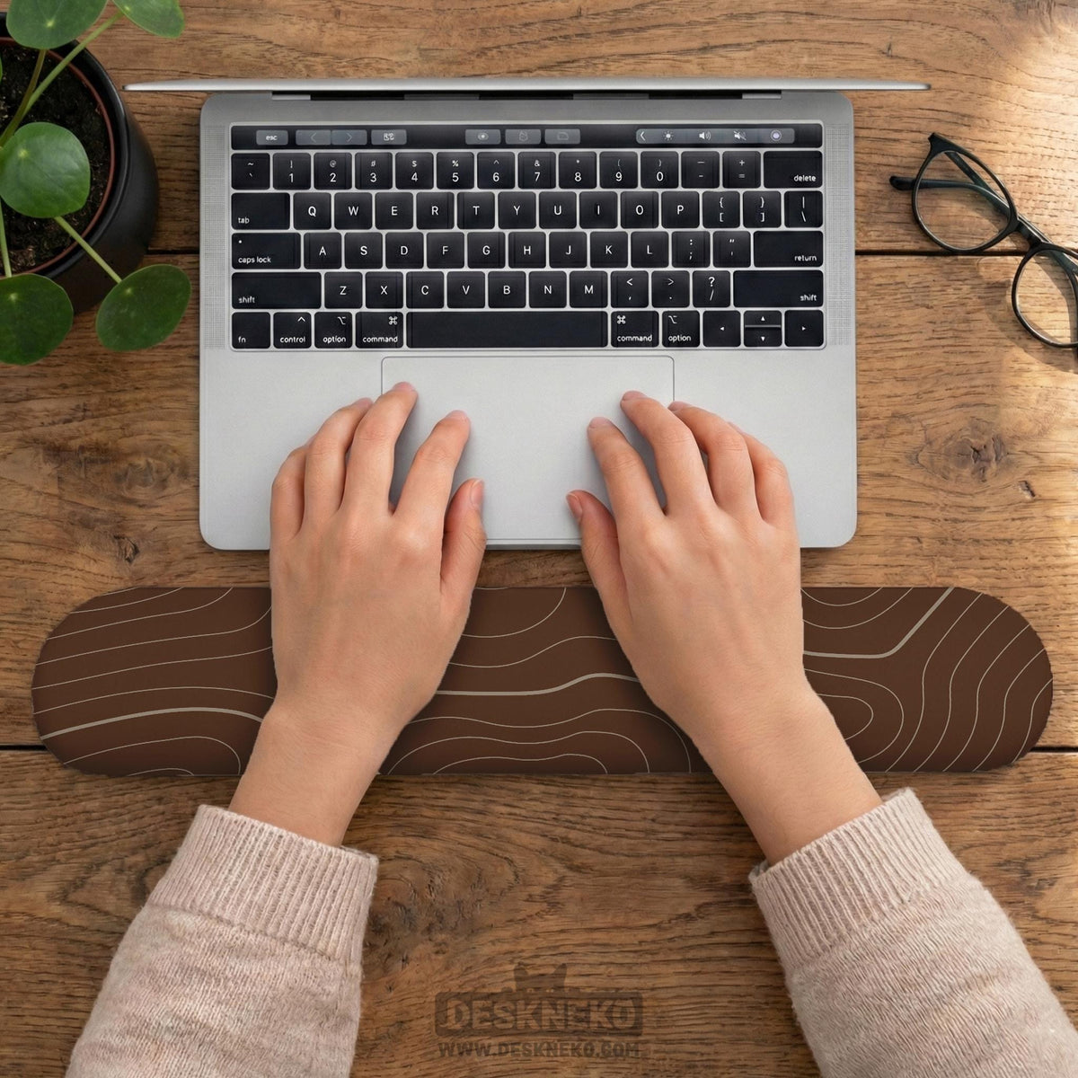 Brown mousepad and keyboard wrist rest with a topographic contour-line pattern.