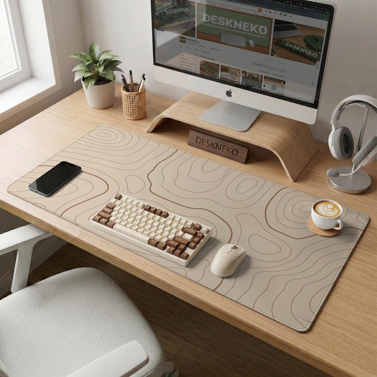 Beige desk mat with soft brown topographic contour lines on a neutral background.