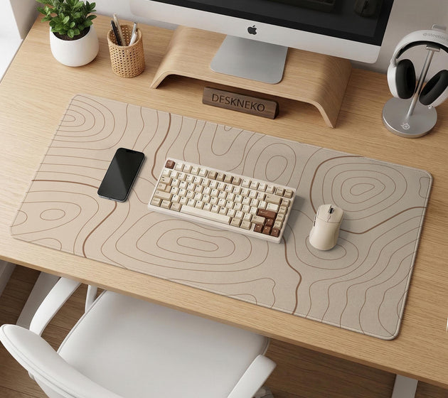 Beige desk mat with soft brown topographic contour lines on a neutral background.