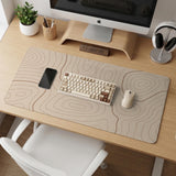 Beige desk mat with soft brown topographic contour lines on a neutral background.