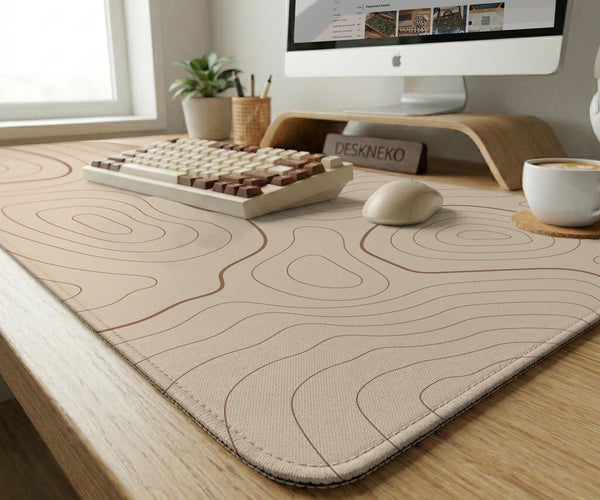 A beige mousepad with a topographic line pattern in a repeating design.