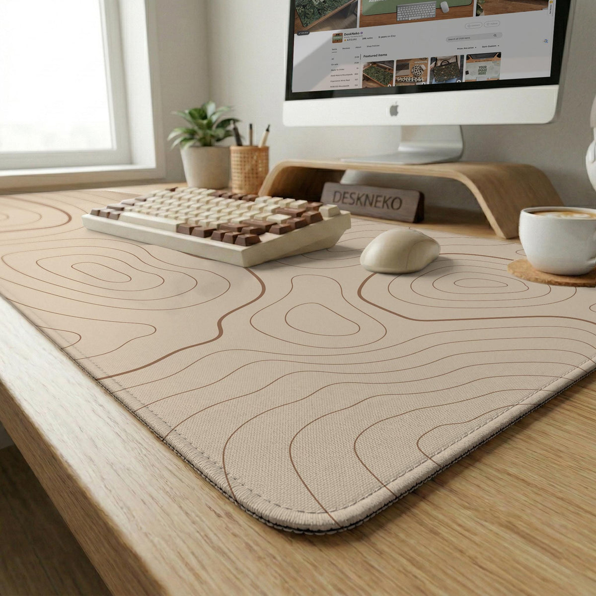 Beige desk mat with soft brown topographic contour lines on a neutral background.