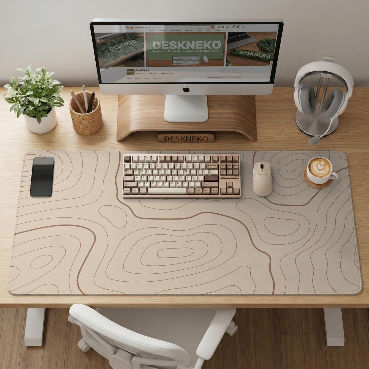 Beige desk mat with soft brown topographic contour lines on a neutral background.