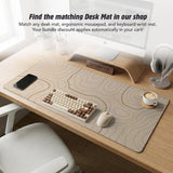 Beige mousepad and keyboard wrist rest with a topographic line pattern shown in a neutral desk setup.