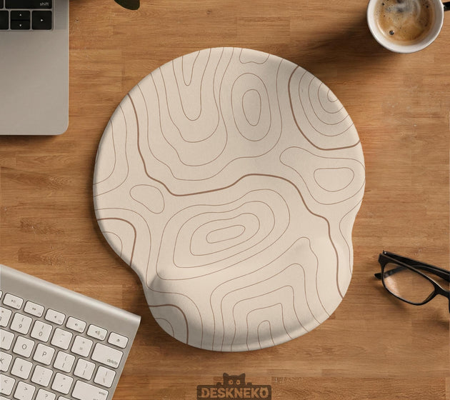 Beige mousepad and keyboard wrist rest with a topographic line pattern shown in a neutral desk setup.