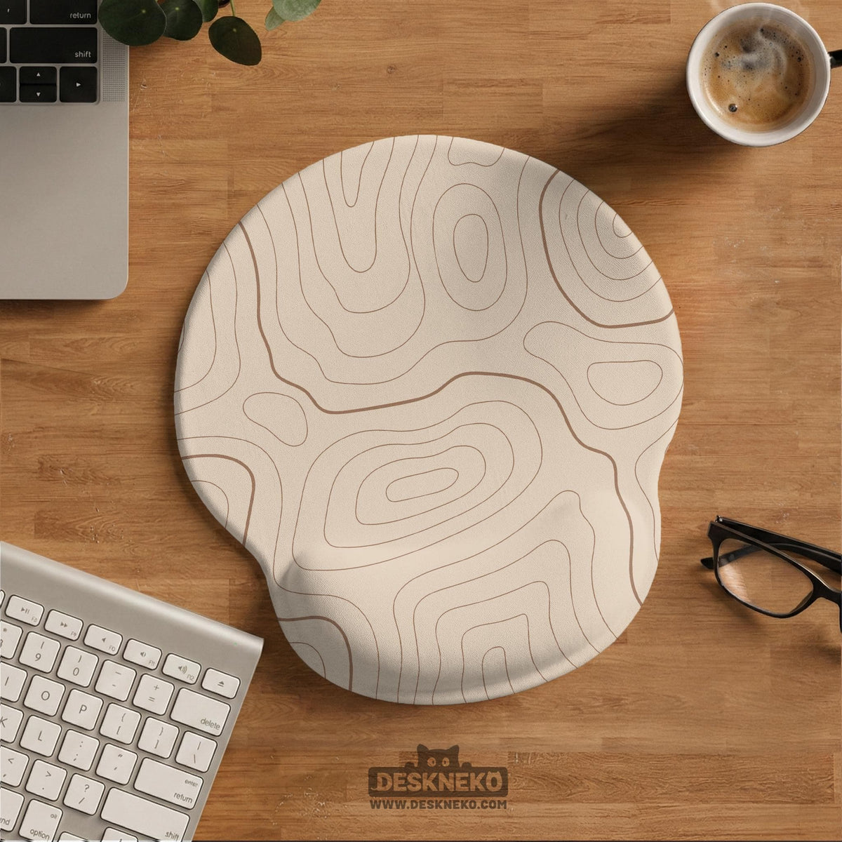 Beige mousepad and keyboard wrist rest with a topographic line pattern shown in a neutral desk setup.