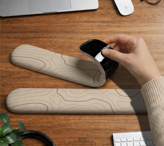 Beige mousepad and keyboard wrist rest with a topographic line pattern shown in a neutral desk setup.