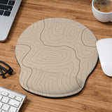 Beige mousepad and keyboard wrist rest with a topographic line pattern shown in a neutral desk setup.