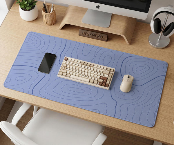 A pastel blue mousepad with an abstract topographic contour line pattern.