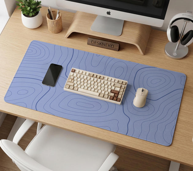 A pastel blue mousepad with an abstract topographic contour line pattern.