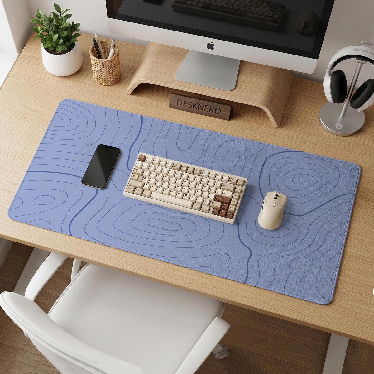 A pastel blue mousepad with an abstract topographic contour line pattern.