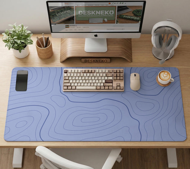 A pastel blue mousepad with an abstract topographic contour line pattern.