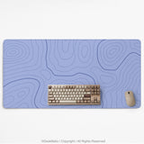 A pastel blue mousepad with an abstract topographic contour line pattern.
