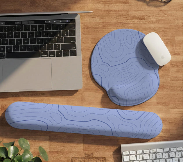 Periwinkle ergonomic mousepad and keyboard wrist rest with a light blue topographic contour line pattern.