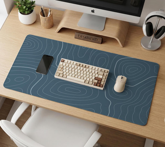 Blue mousepad with a topographic line pattern on a slate background.