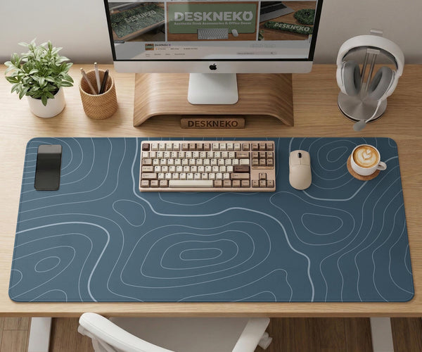 Blue mousepad with a topographic line pattern on a slate background.