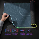 A slate blue desk mat with thin contour line map art on a light background.