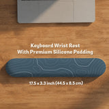 A slate blue desk mat with thin contour line map art on a light background.
