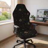 Black chair cover with a dark galaxy pattern, muted gold stars and celestial artwork on a chair.