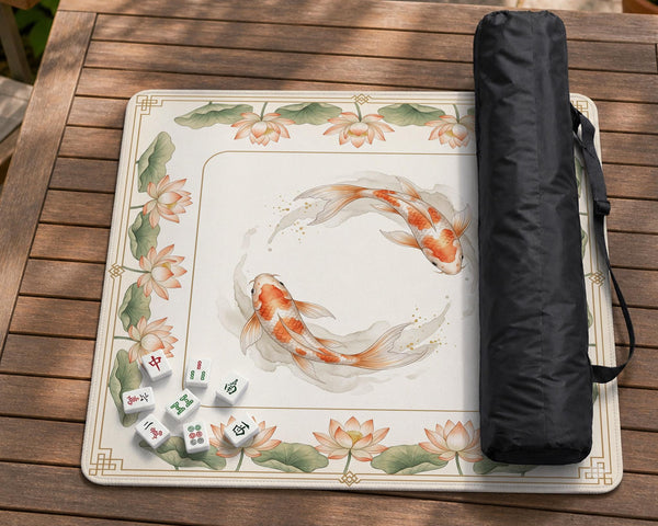 Ivory square mahjong mat with watercolor koi fish, lotus flowers, peach blossoms, sage leaves, and a thin gold border.