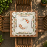 Ivory square mahjong mat with watercolor koi fish, lotus flowers, peach blossoms, sage leaves, and a thin gold border.