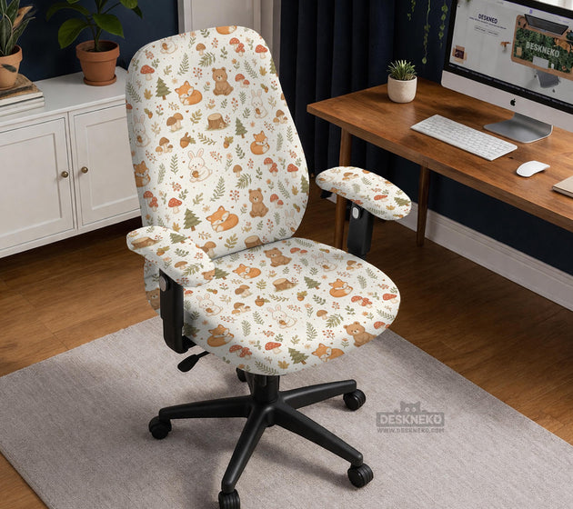 A gaming chair cover with a woodland animal print featuring foxes, rabbits, bears, mushrooms, and leaves in green, brown, and beige tones.