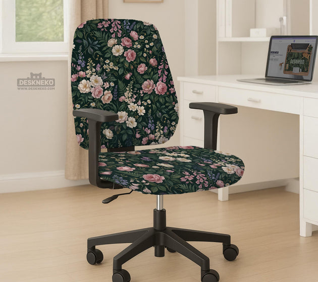 Green chair cover with a dark floral pattern, pink roses, cream flowers, and leafy botanical details on an office chair.