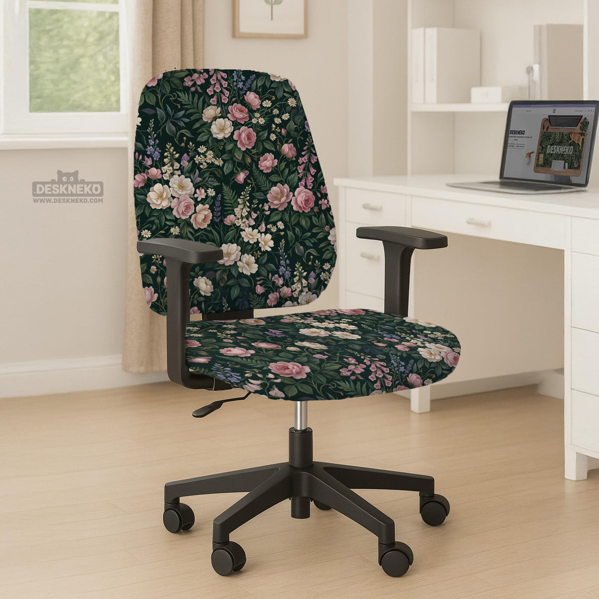 Green chair cover with a dark floral pattern, pink roses, cream flowers, and leafy botanical details on an office chair.