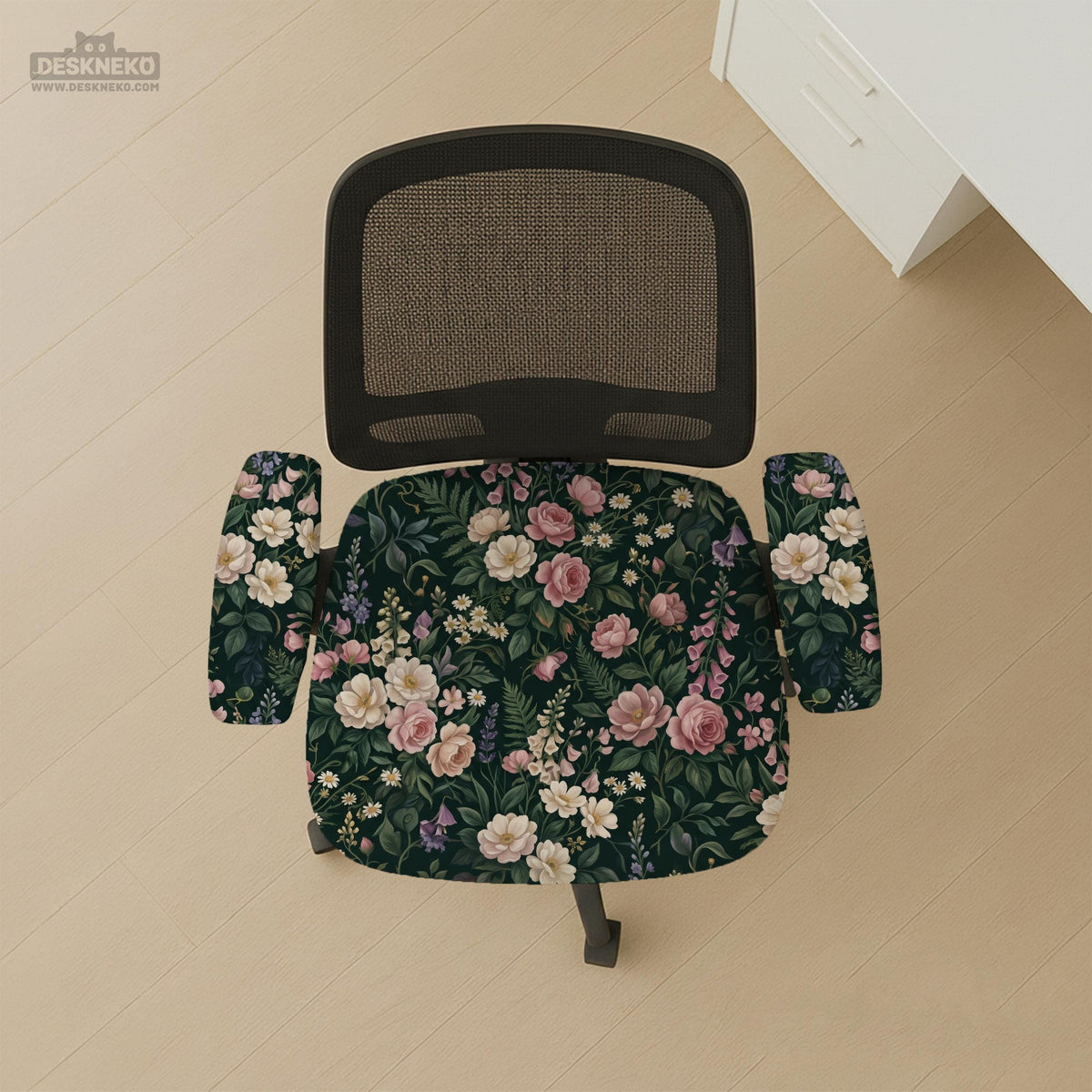Green chair cover with a dark floral pattern, pink roses, cream flowers, and leafy botanical details on an office chair.