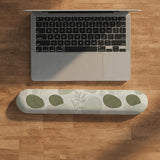 Green abstract botanical mouse pad with a rounded organic pattern and matching keyboard wrist rest option.