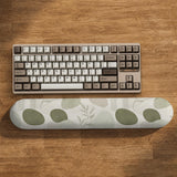 Green abstract botanical mouse pad with a rounded organic pattern and matching keyboard wrist rest option.