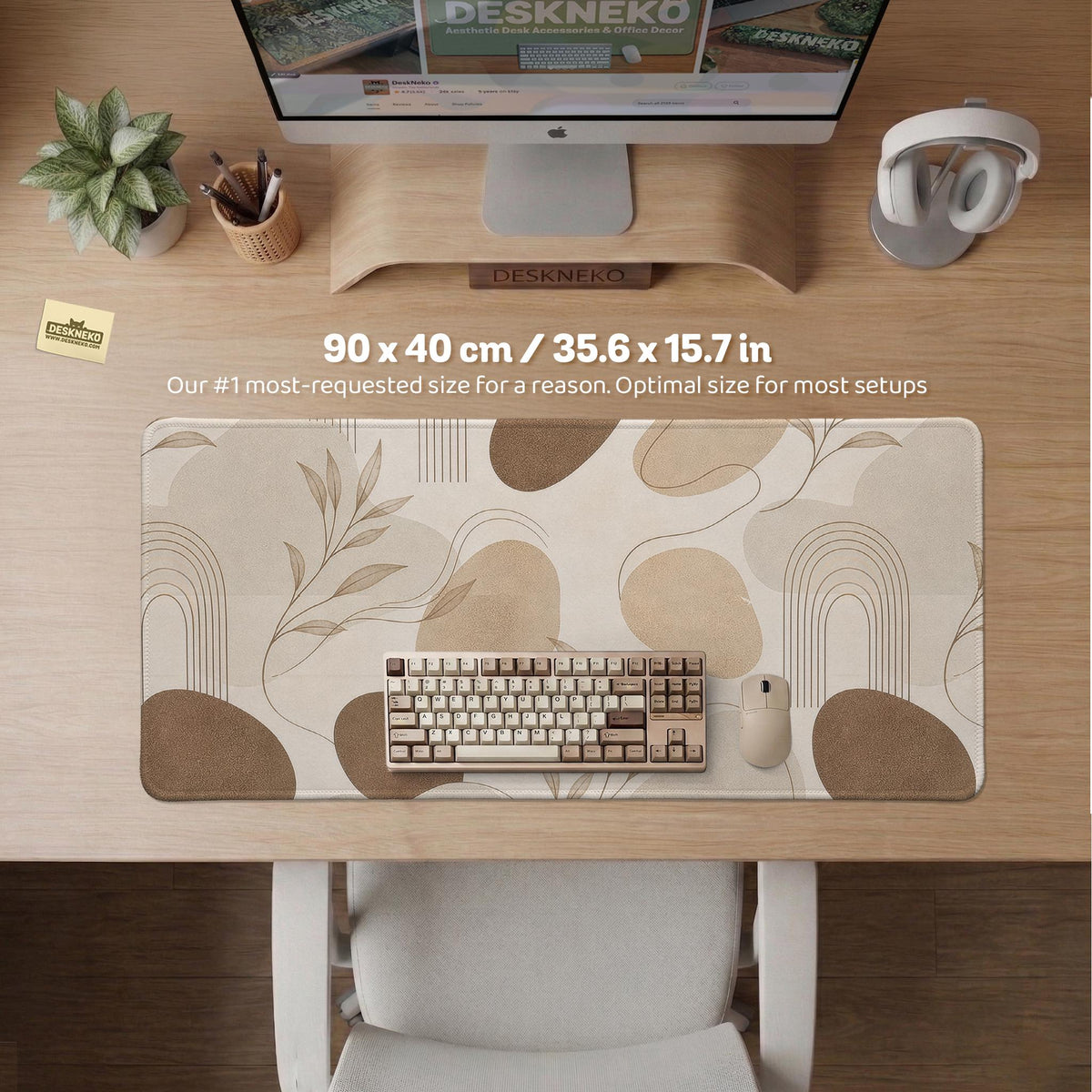 Beige desk mat with fine botanical line drawings and soft abstract shapes on a light neutral background.