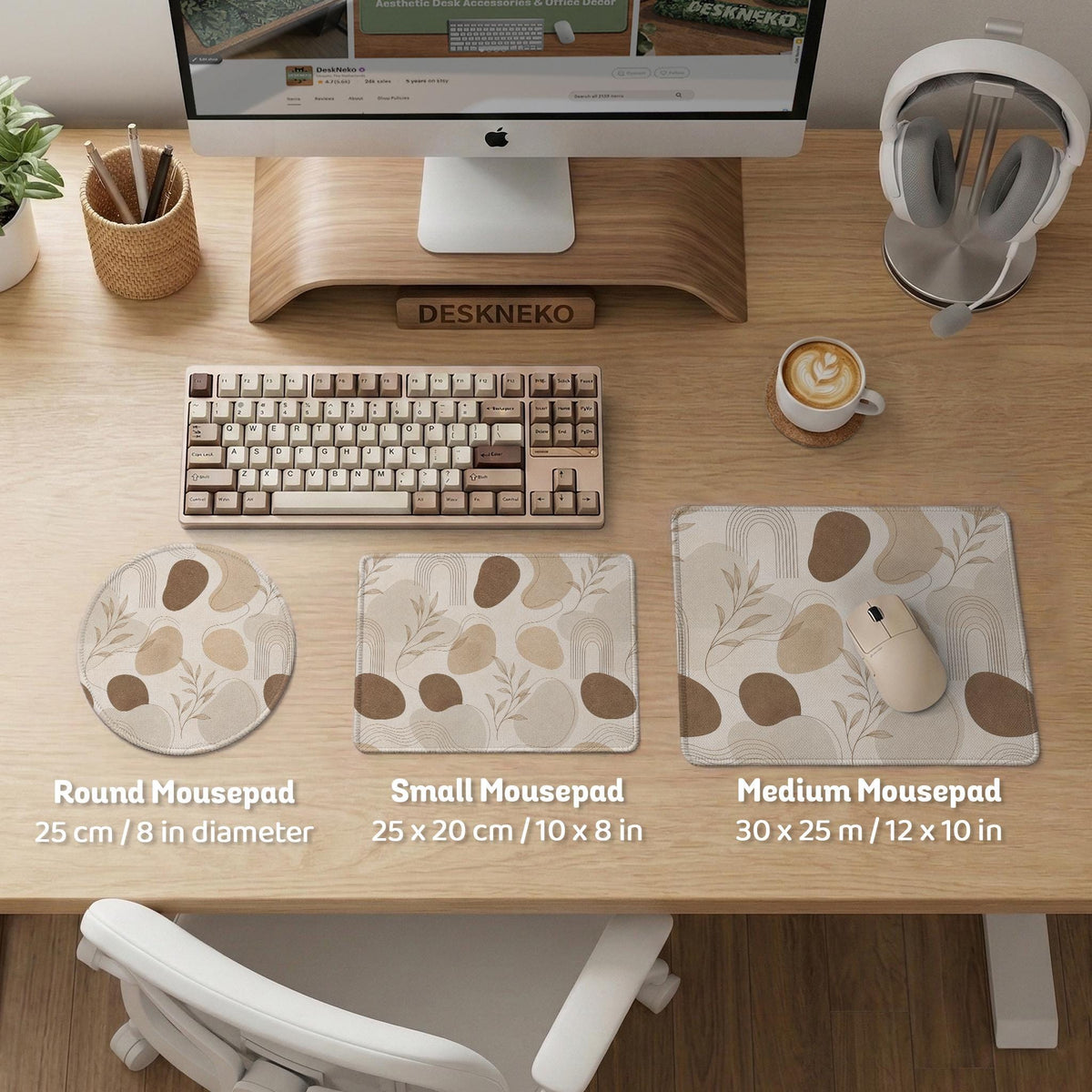 Beige desk mat with fine botanical line drawings and soft abstract shapes on a light neutral background.