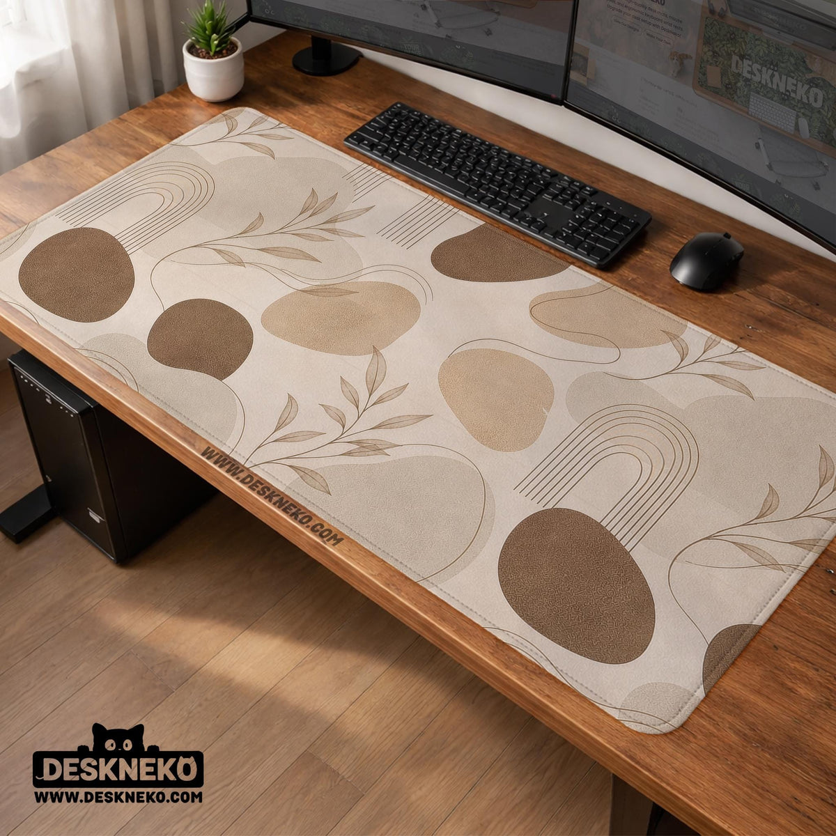 Beige desk mat with fine botanical line drawings and soft abstract shapes on a light neutral background.
