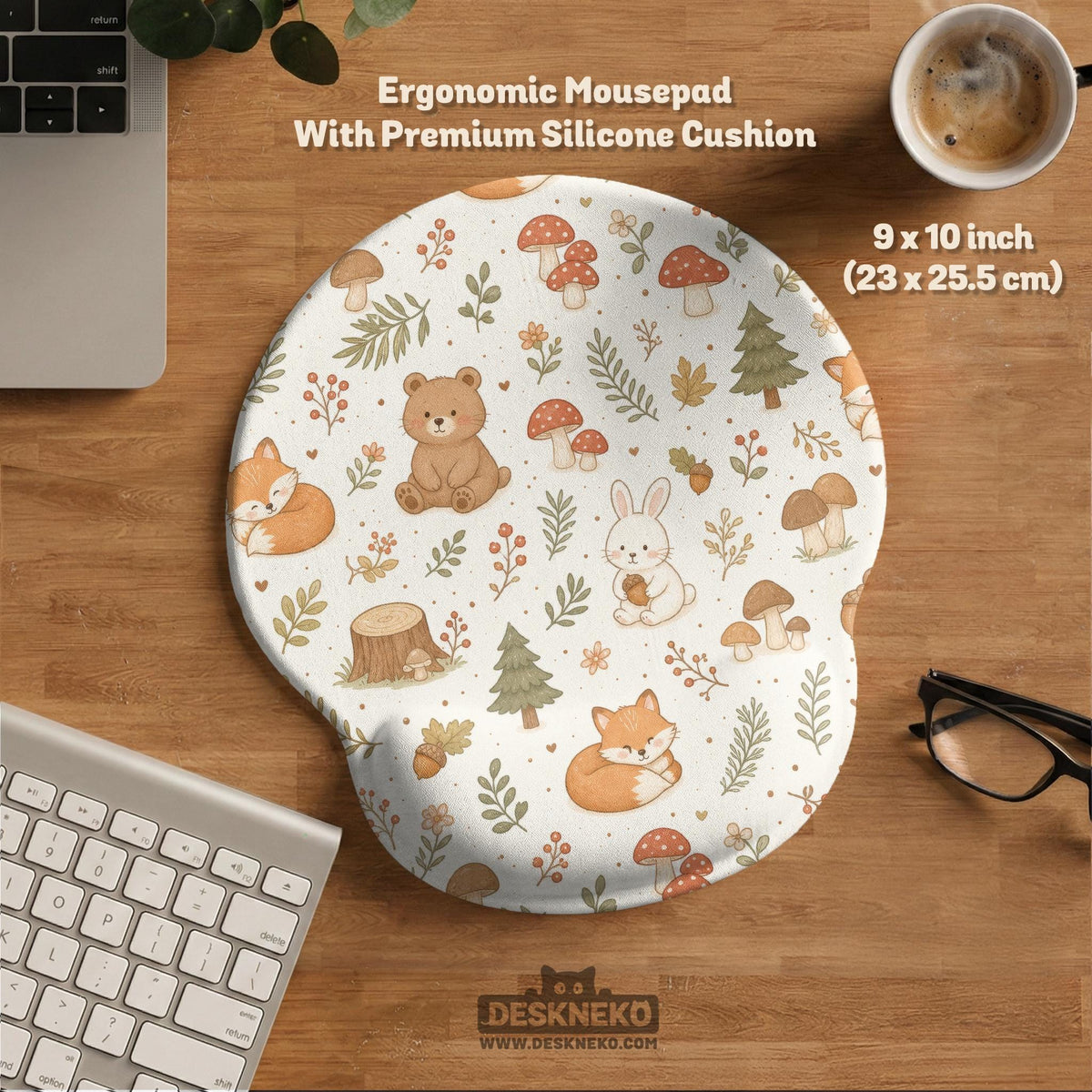 Cream desk mat with a woodland animal pattern featuring foxes, bunnies, mushrooms, berries, acorns, and sage leaves in soft green tones.