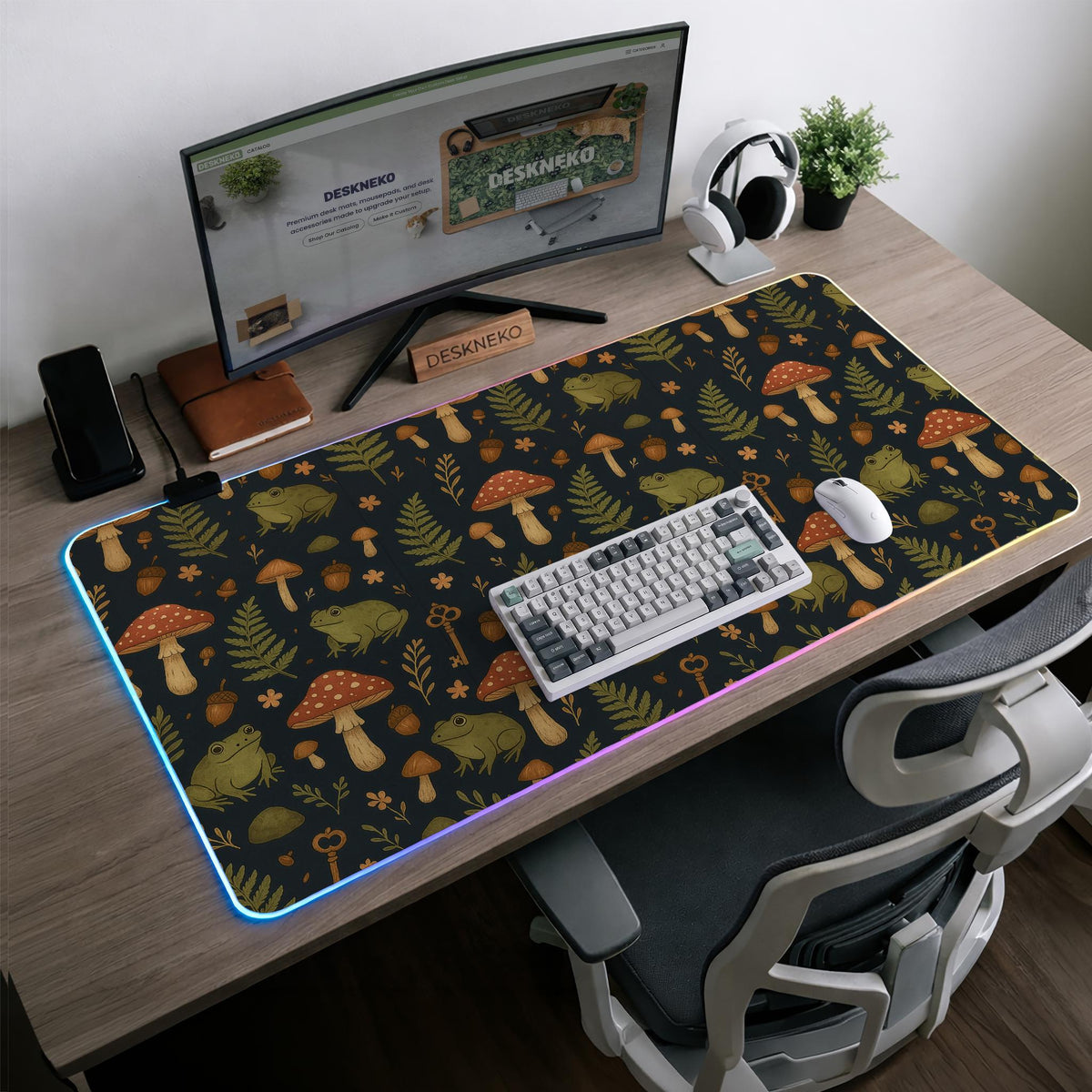 Dark forest-themed desk mat with an all-over pattern of frogs, mushrooms, fern leaves, acorns, tiny flowers, and antique keys.